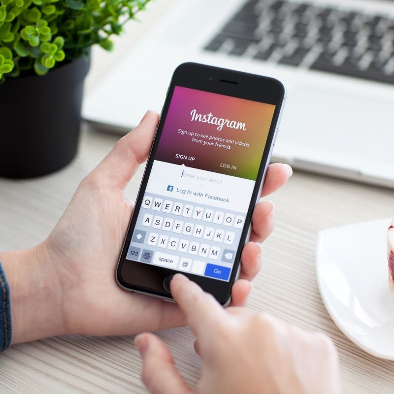 Woman Holding Iphone 6 Space Gray With Service Instagram Alushta Russia - October 28 2014: Woman holding a iPhone 6 Space Gray with social networking service Instagram on the screen. iPhone 6 was created and developed by the Apple inc.